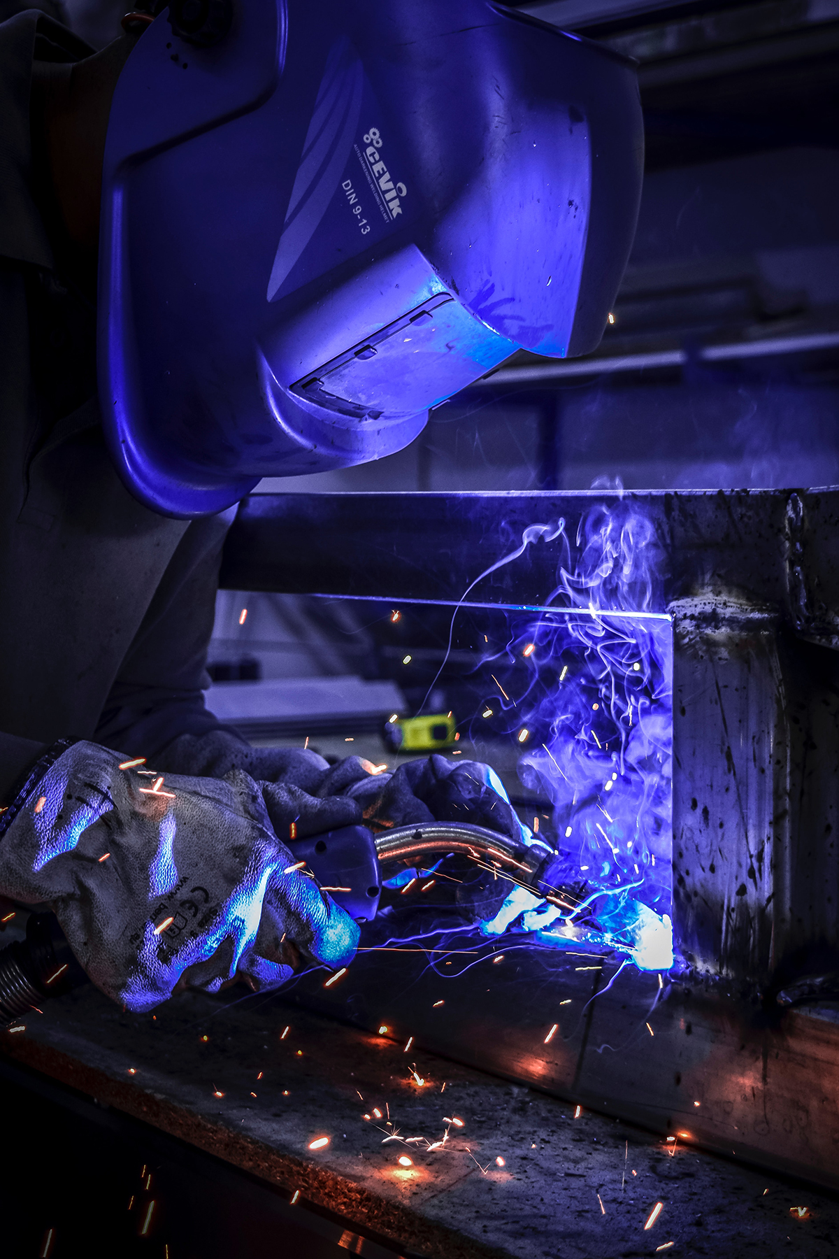 welder in a helmet working on a project